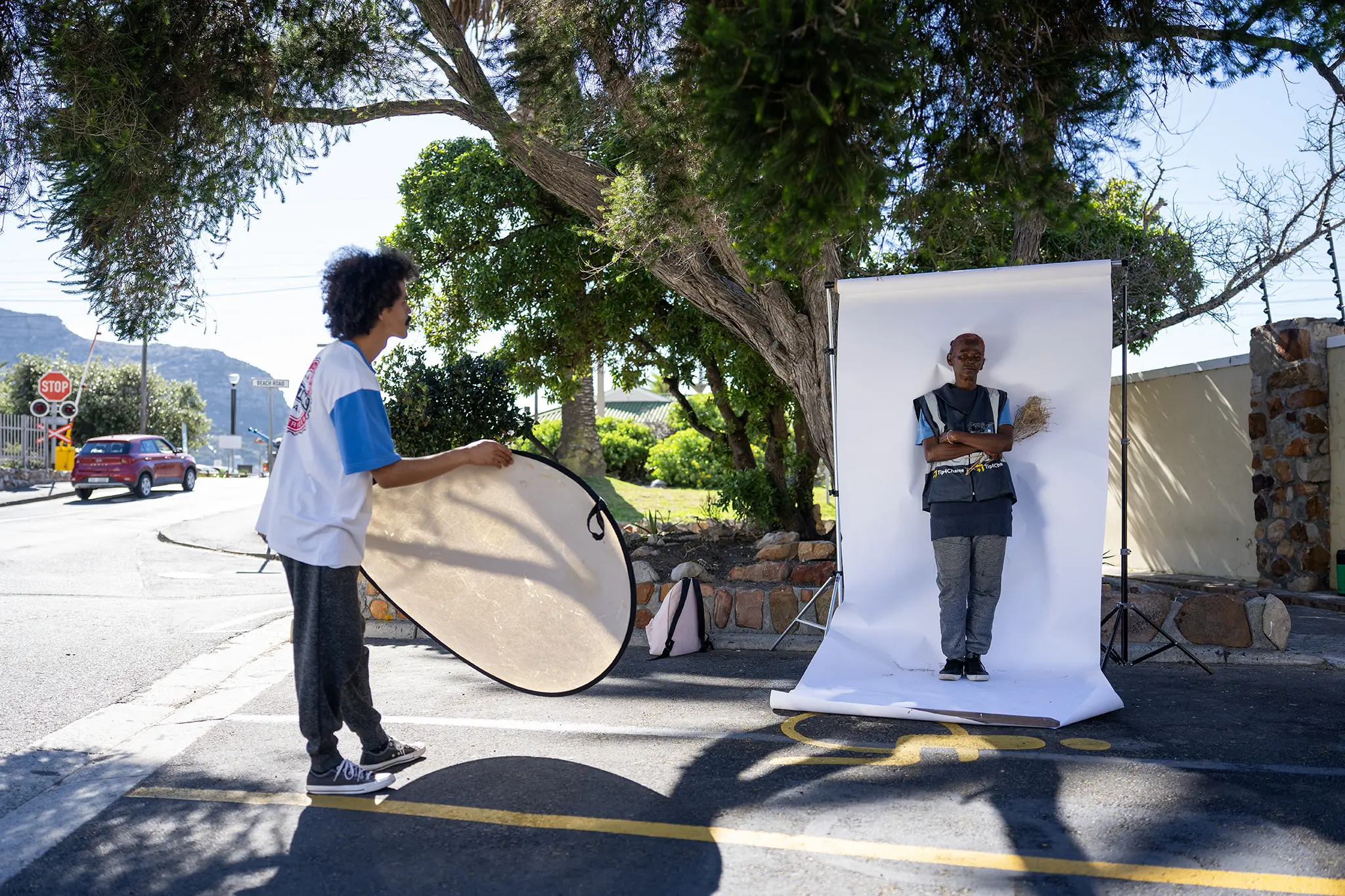 Behind-the-scenes: Claudine Harris being photographed in an outdoor portrait studio