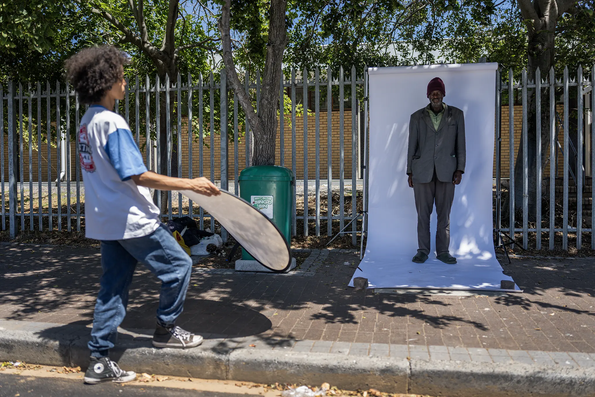 Behind-the-scenes: Charles Matika being photographed in an outdoor portrait studio