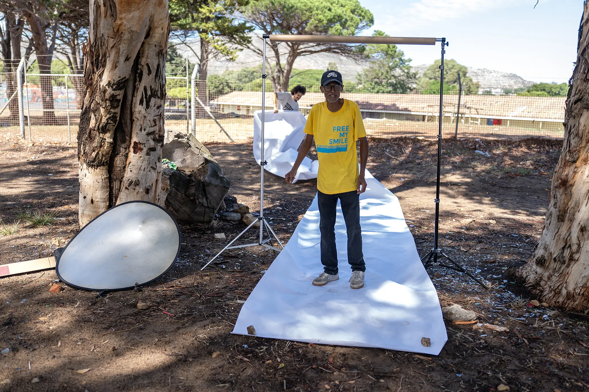  A behind the scenes image after the wind blew open the role of paper used for the backdrop to take portraits of Marlon in Ocean View. 